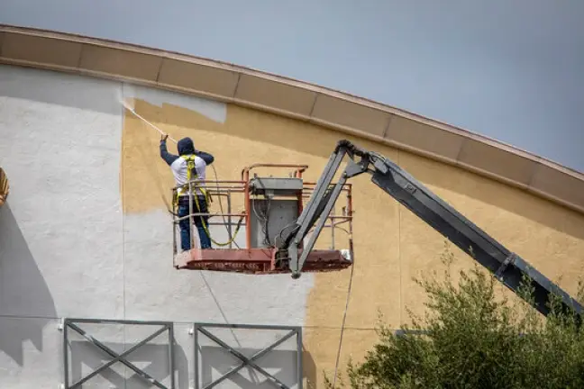 professional standing on life painting commercial property white